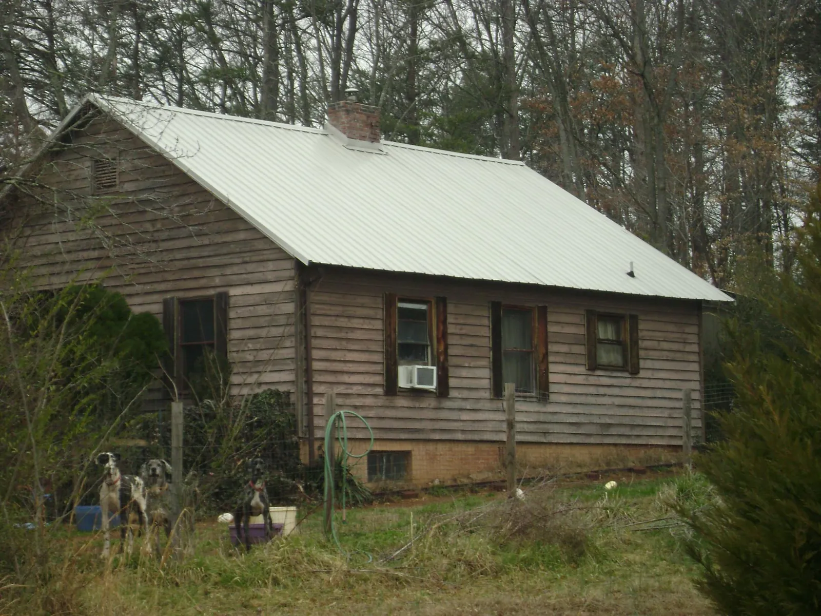 White metal roof on an old wood sided farmhouse, from a Asphalt Shingle Roof Repair job in Moravian Falls